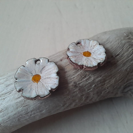 Flower shaped stud earrings in white enamel with  hand painted  detail. 