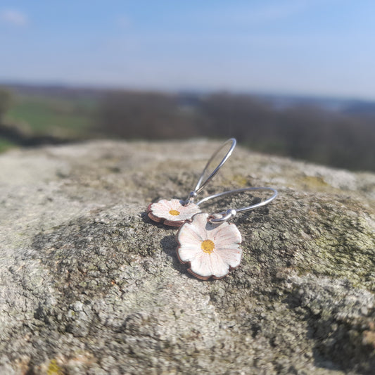 fluted white daisy like flower earring, with delicate handpainted detail and yellow centre. on silver ear wires. 